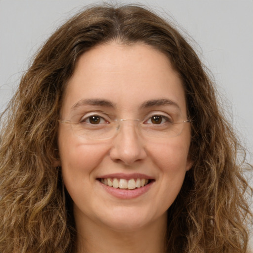 Joyful white young-adult female with long  brown hair and green eyes