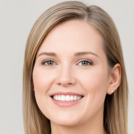 Joyful white young-adult female with long  brown hair and grey eyes