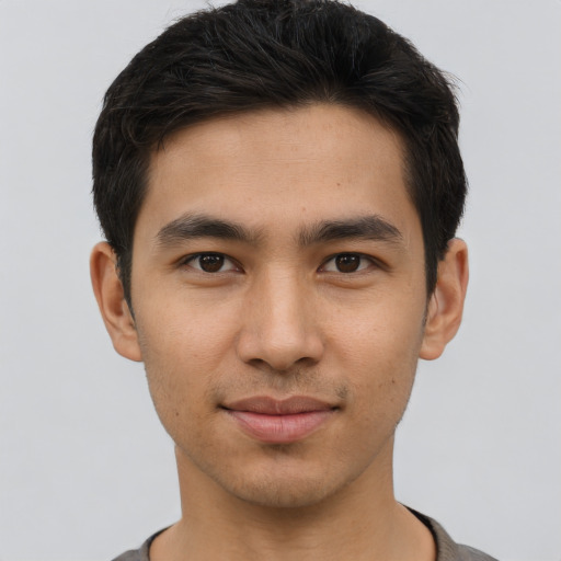 Joyful asian young-adult male with short  brown hair and brown eyes