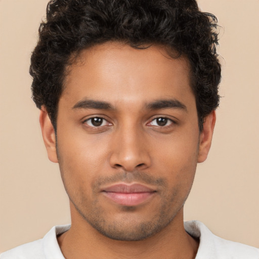 Joyful black young-adult male with short  brown hair and brown eyes