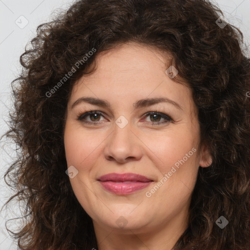 Joyful white adult female with long  brown hair and brown eyes