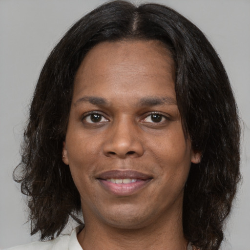 Joyful black young-adult female with medium  brown hair and brown eyes