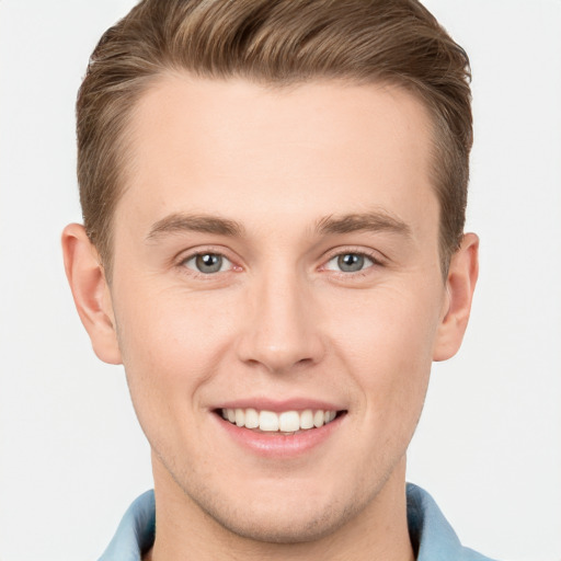 Joyful white young-adult male with short  brown hair and grey eyes