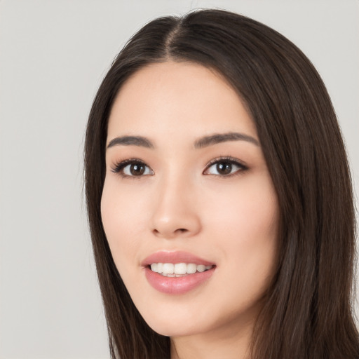 Joyful white young-adult female with long  black hair and brown eyes