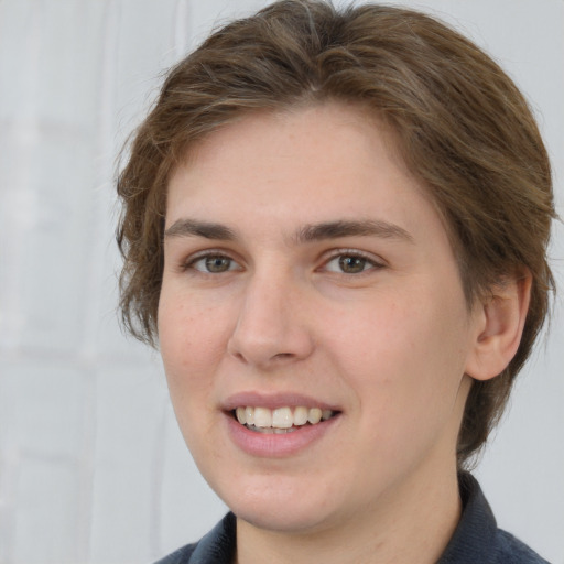 Joyful white young-adult female with medium  brown hair and grey eyes