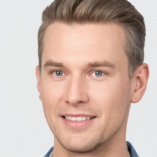 Joyful white young-adult male with short  brown hair and grey eyes