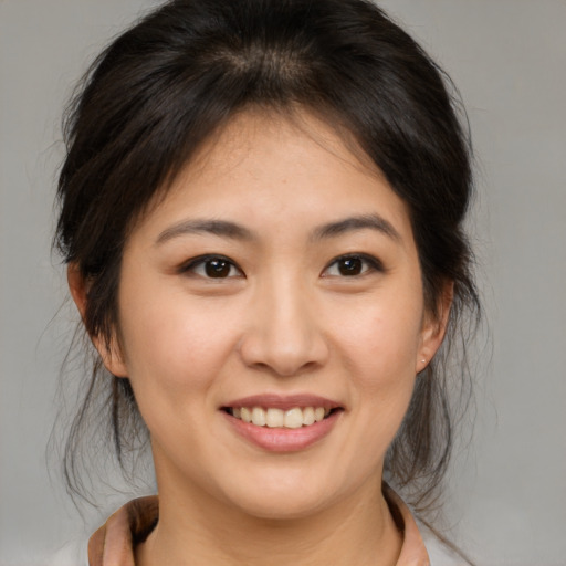 Joyful asian young-adult female with medium  brown hair and brown eyes