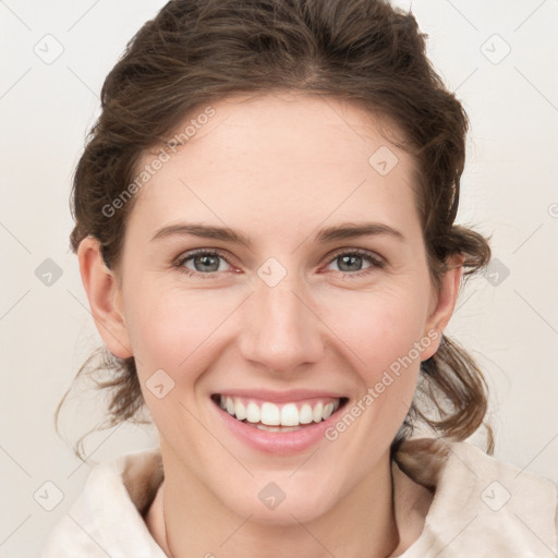 Joyful white young-adult female with medium  brown hair and green eyes