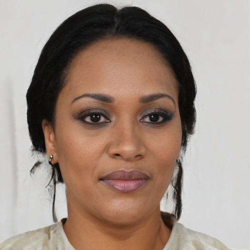 Joyful black young-adult female with medium  black hair and brown eyes