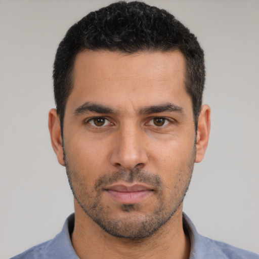 Neutral latino young-adult male with short  black hair and brown eyes