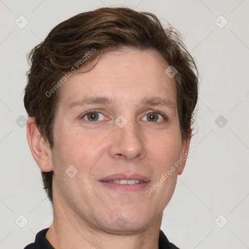 Joyful white adult male with short  brown hair and grey eyes