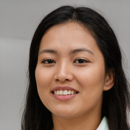 Joyful asian young-adult female with long  brown hair and brown eyes