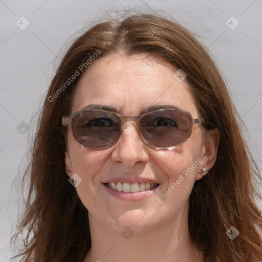 Joyful white adult female with long  brown hair and grey eyes