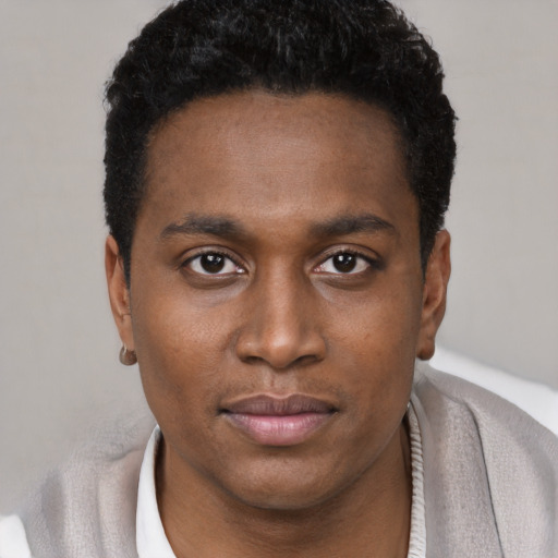 Joyful black young-adult male with short  black hair and brown eyes
