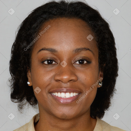 Joyful black young-adult female with medium  brown hair and brown eyes