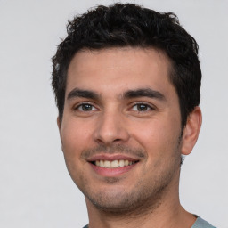 Joyful white young-adult male with short  black hair and brown eyes