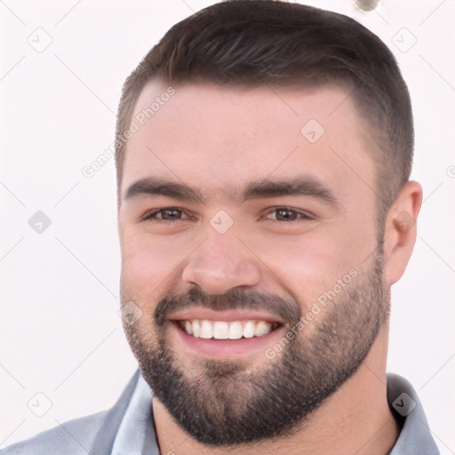 Joyful white young-adult male with short  brown hair and brown eyes