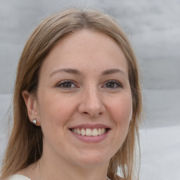 Joyful white young-adult female with medium  brown hair and grey eyes