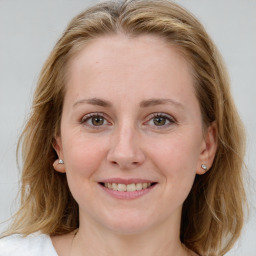 Joyful white young-adult female with medium  brown hair and blue eyes