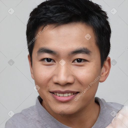 Joyful asian young-adult male with short  black hair and brown eyes