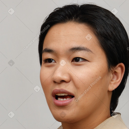 Joyful asian young-adult female with short  black hair and brown eyes