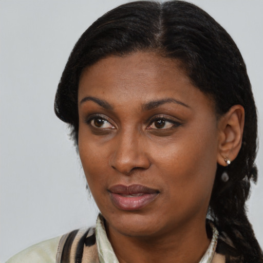 Joyful black young-adult female with medium  black hair and brown eyes
