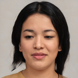 Joyful asian young-adult female with medium  black hair and brown eyes