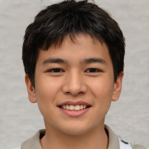 Joyful asian child male with short  brown hair and brown eyes