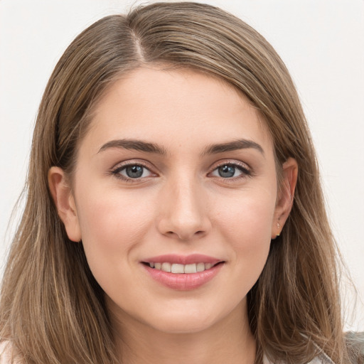 Joyful white young-adult female with long  brown hair and grey eyes