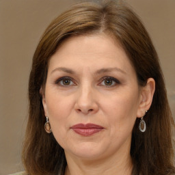 Joyful white adult female with long  brown hair and brown eyes