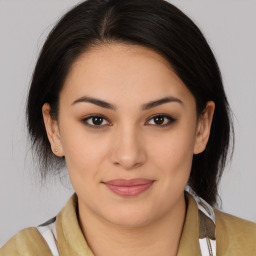 Joyful latino young-adult female with medium  brown hair and brown eyes