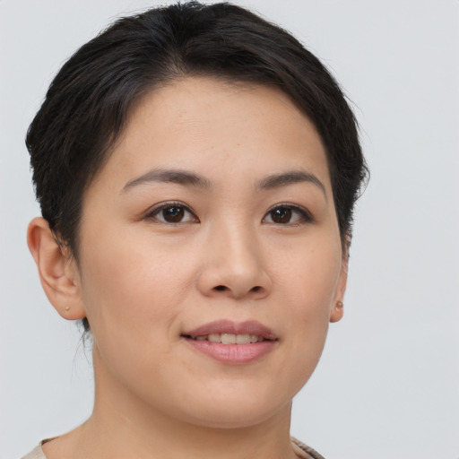 Joyful asian young-adult female with short  brown hair and brown eyes