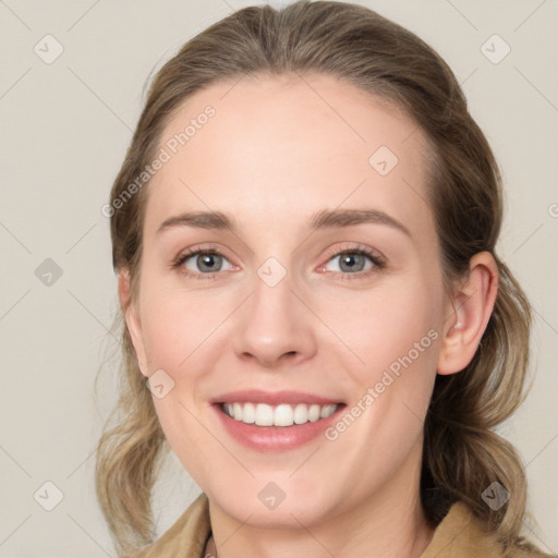 Joyful white young-adult female with medium  brown hair and green eyes