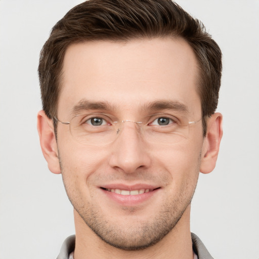 Joyful white young-adult male with short  brown hair and grey eyes