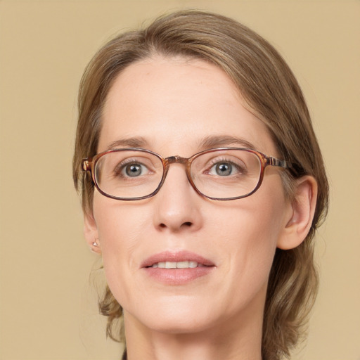 Joyful white adult female with medium  brown hair and blue eyes