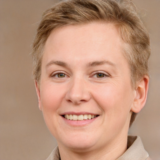 Joyful white young-adult female with short  brown hair and grey eyes