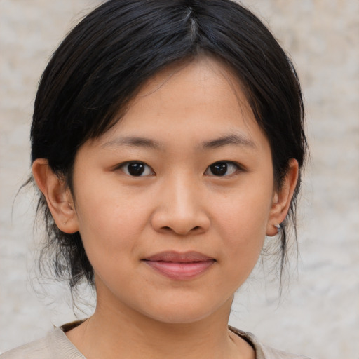 Joyful asian young-adult female with medium  brown hair and brown eyes