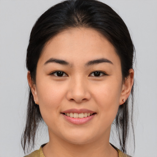 Joyful asian young-adult female with medium  brown hair and brown eyes