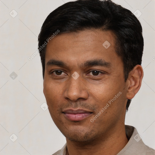 Joyful latino young-adult male with short  black hair and brown eyes