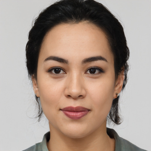 Joyful latino young-adult female with medium  black hair and brown eyes