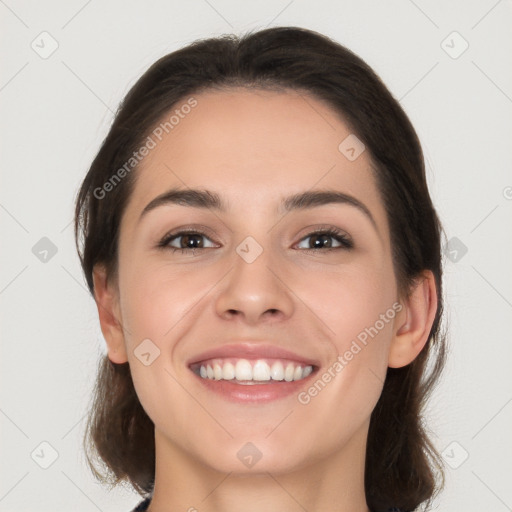 Joyful white young-adult female with long  brown hair and brown eyes