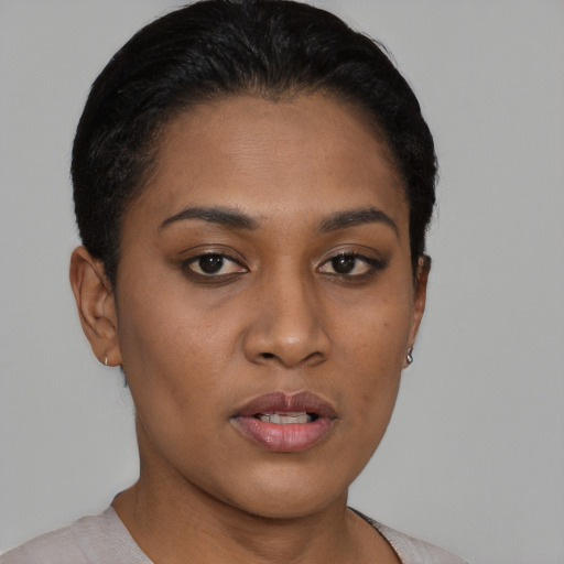 Joyful black young-adult female with short  black hair and brown eyes