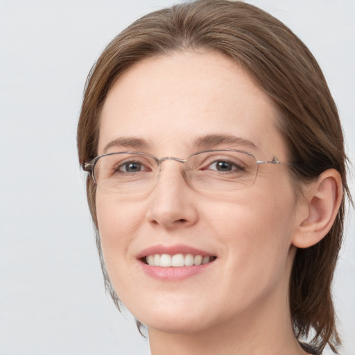 Joyful white adult female with medium  brown hair and blue eyes