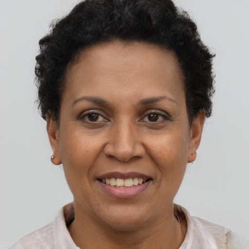 Joyful latino adult female with short  brown hair and brown eyes