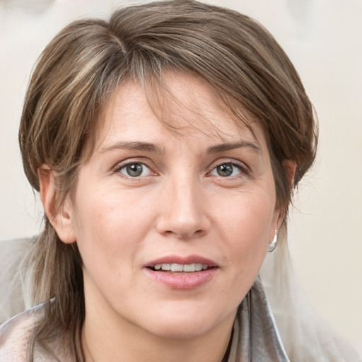 Joyful white young-adult female with medium  brown hair and grey eyes