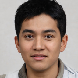 Joyful asian young-adult male with short  black hair and brown eyes