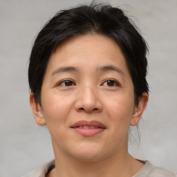 Joyful asian young-adult female with short  brown hair and brown eyes