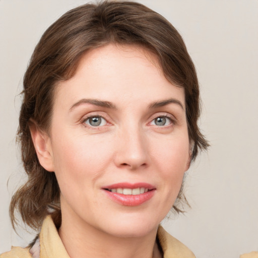 Joyful white young-adult female with medium  brown hair and blue eyes