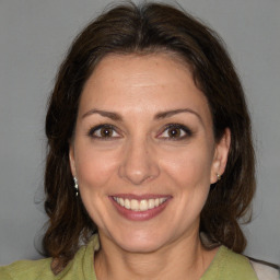 Joyful white adult female with medium  brown hair and brown eyes