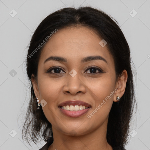 Joyful latino young-adult female with long  brown hair and brown eyes